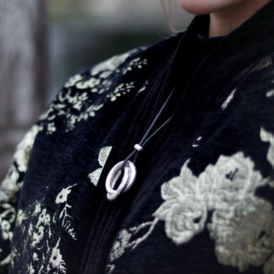 A lifestyle shot demonstrating the everyday wear of the Taoist flagship pendant, blending high-end craftsmanship with spiritual guard.