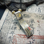 Back view of the pendant showing the Tai Chi symbol and fortune mantras for wealth attraction and luck reversal.