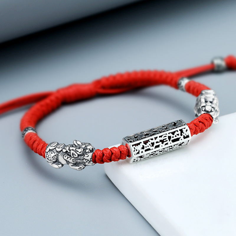 Taiji aura bracelet red braided cord with sterling silver dual Pixiu wealth guardian and lock bead closeup on white background Taoist KaiGuang