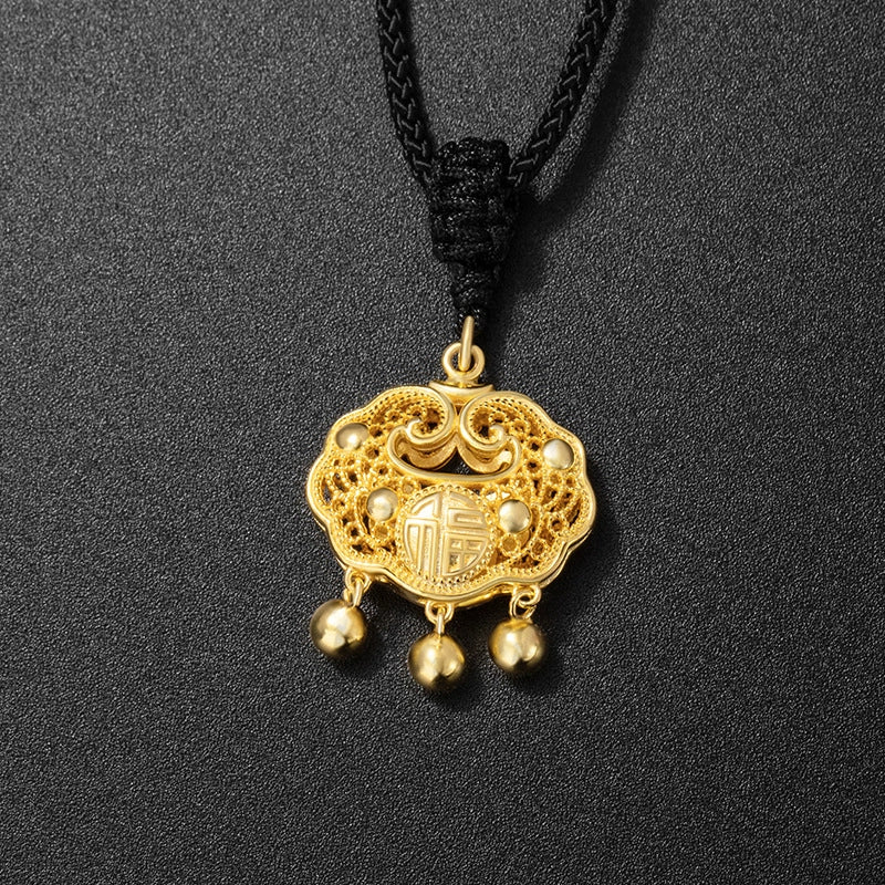 Taoist KaiGuang peace lock gold pendant with Fu character and three gold bead tassel full view on black background protection fortune turning jewelry