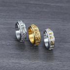  Gold and silver Taoist rune spinner rings flat lay on dark background showing engraved details