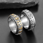 Two gold and silver Taoist spinner rings side view showing rotatable band and rune engravings