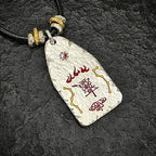 Macro view of the back of the hammered silver pendant featuring the supreme evil-banishing symbols and North Star formation.
