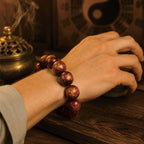 Man wearing thunderstruck jujube wood protection bracelet for spiritual cleansing, Taoist yin-yang backdrop