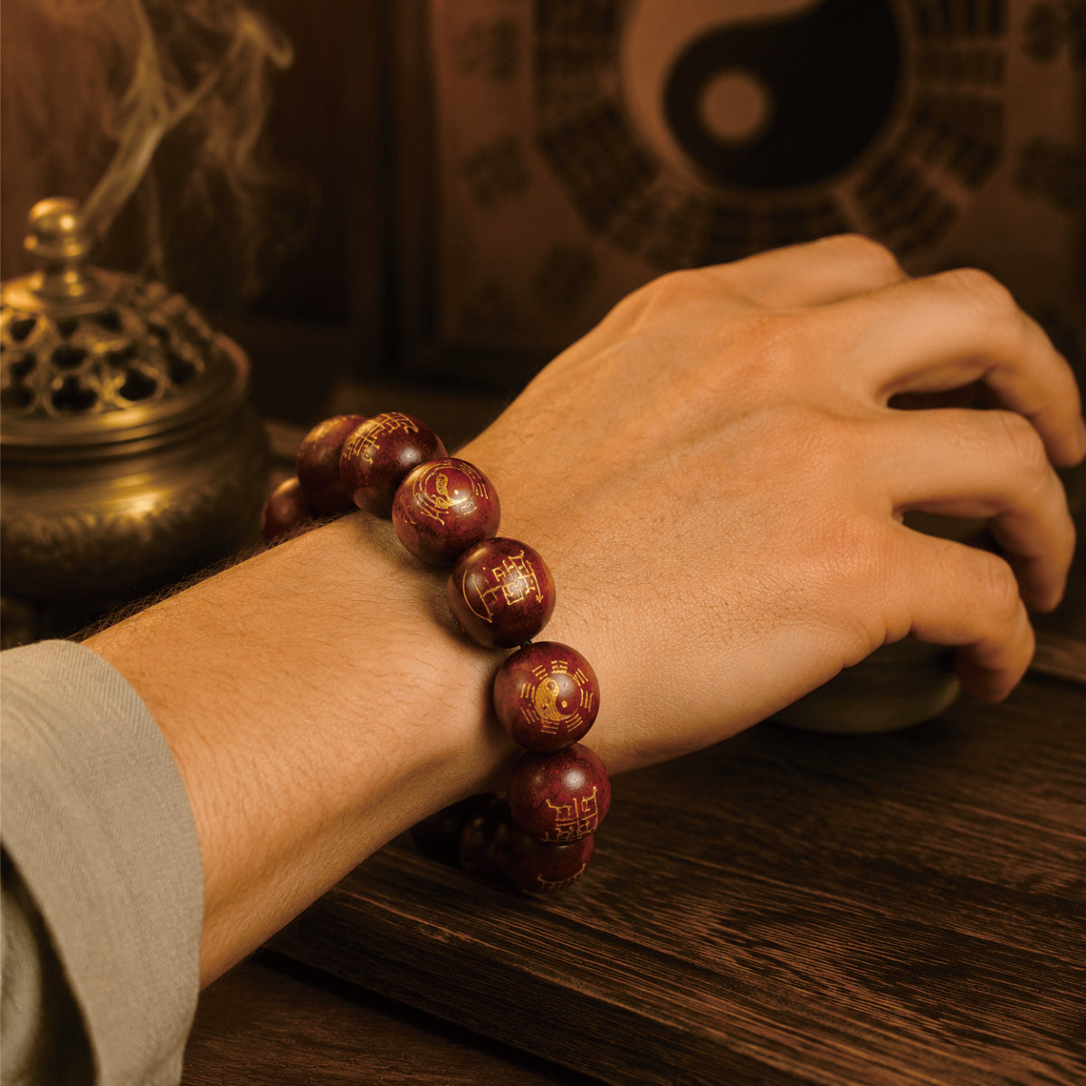 Man wearing thunderstruck jujube wood protection bracelet for spiritual cleansing, Taoist yin-yang backdrop