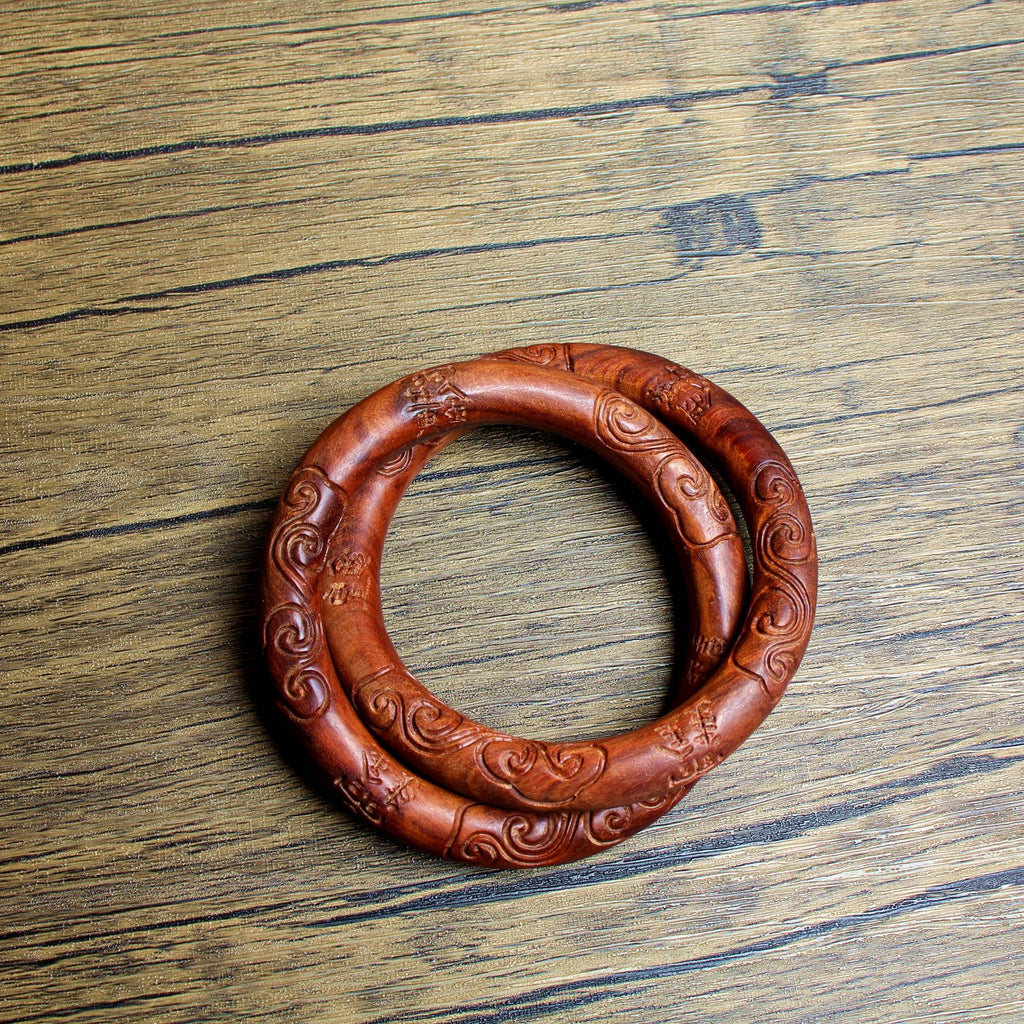 Macro detail of the supreme energy commands etched onto the Yin-Yang Ring, featuring cloud patterns and Taoist talismans on aged thunderstruck wood.