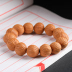 Close-up of natural wild walnut bracelet beads showing original skin grain texture on white background Taoist KaiGuang wealth attraction grounding energy
