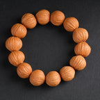 Natural wild walnut wealth bracelet full circle view on dark background showing original skin texture Taoist KaiGuang grounding positive energy spiritual jewelry