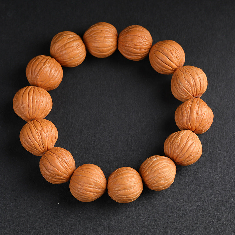 Natural wild walnut wealth bracelet full circle view on dark background showing original skin texture Taoist KaiGuang grounding positive energy spiritual jewelry