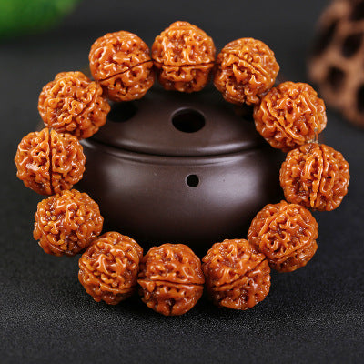 Aged Walnut beads with deep patina on a Taoist vessel for financial security.