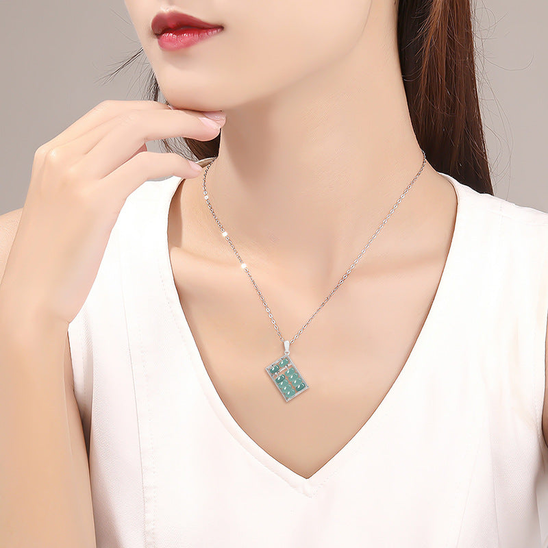 woman wearing natural jade abacus pendant necklace white top taoist kaiguang fortune turn wealth