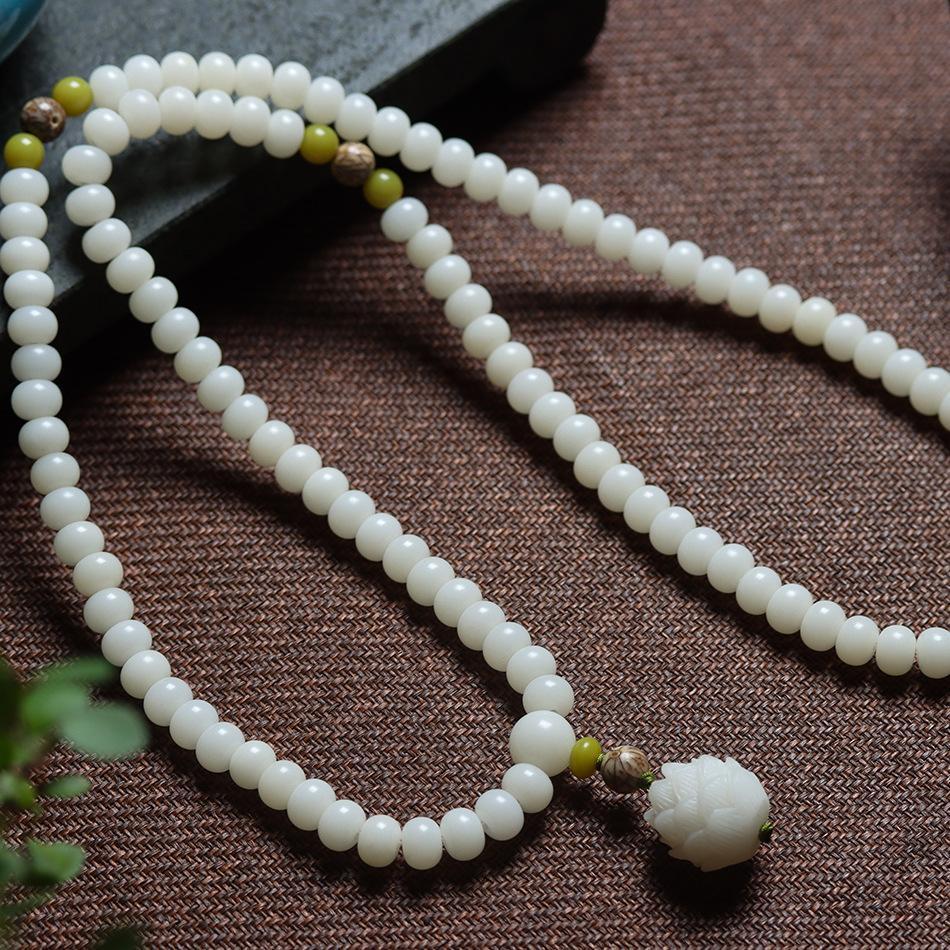 High-density white jade bodhi root beads for spiritual purification and detox.