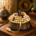 White flower beeswax yellow beeswax 108 bead mala draped on gourd ornament with yin yang bagua backdrop and incense smoke Taoist KaiGuang meditation tool deep stillness