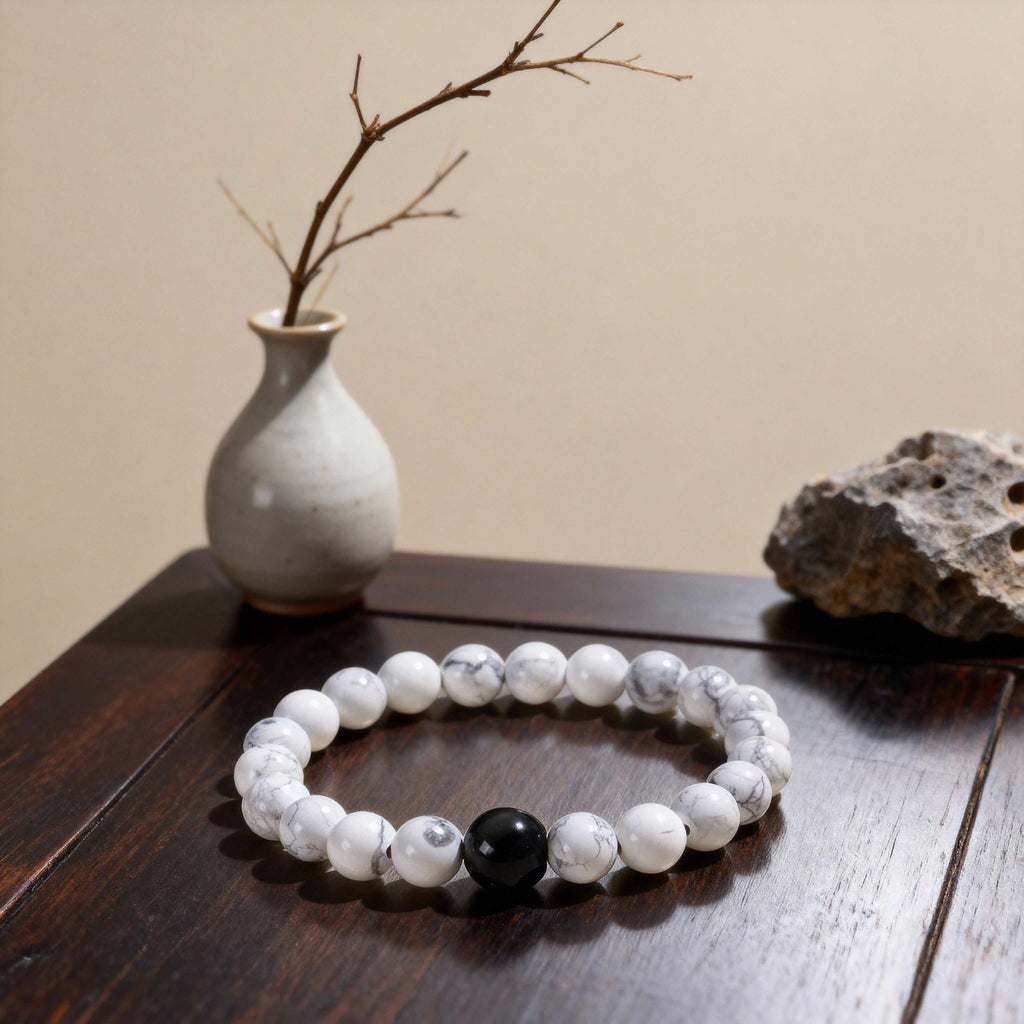 Close-up of female feng shui bracelet with white turquoise beads, each bead showing unique natural map-like patterns