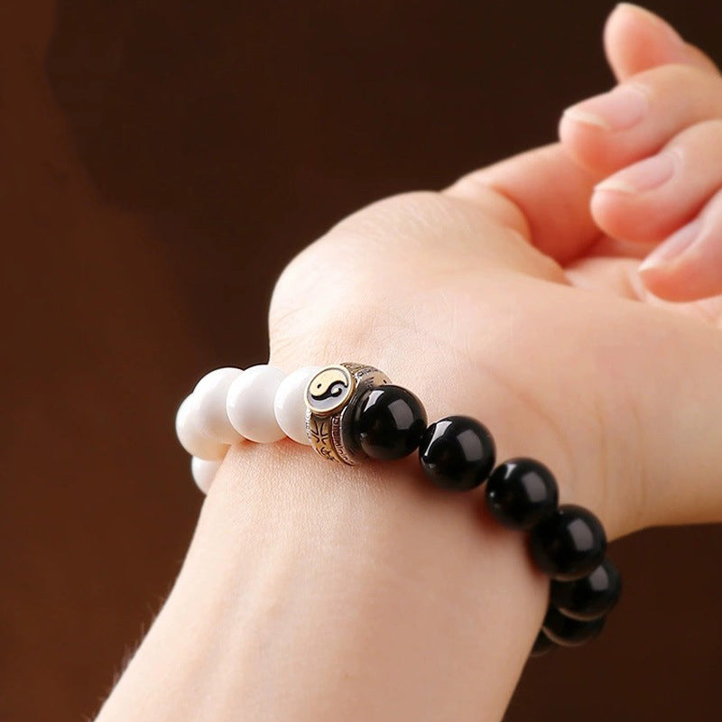 fwoman wearing white turquoise yin yang bracelet taoist kaiguang energy balance bracelet women