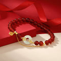Women love attraction bracelet with deep red agate beads white jade peace clasp gold auspicious cloud setting and Fu charm on red silk background Taoist KaiGuang jewelry