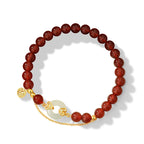 Women love attraction bracelet full circle view on white background deep red agate beads with white jade peace clasp gold chain and Fu character charm Taoist KaiGuang amulet