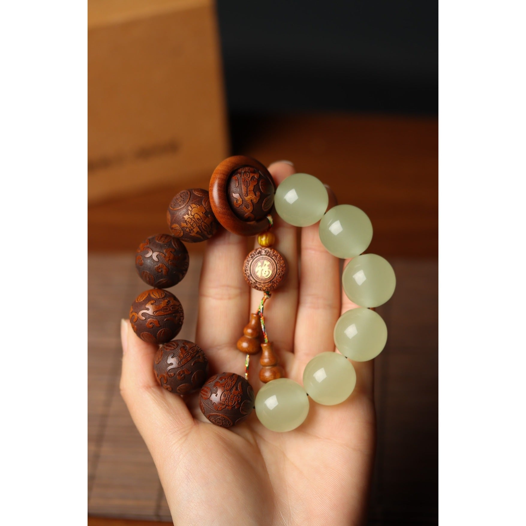 Yin yang bracelet white quartz Yang beads and carved tea wood Yin beads held in hand showing full circle Taoist KaiGuang meditation talisman