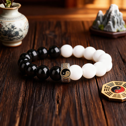 black obsidian white turquoise yin yang tai chi bracelet flat lay taoist kaiguang energy balance
