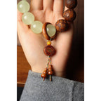 Yin yang talisman bracelet Fu copper pendant and tassel closeup held in palm white quartz tea wood Taoist KaiGuang meditation jewelry
